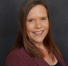 A woman smiling for the camera.