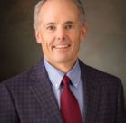 Joel Cooper in a suit and tie.