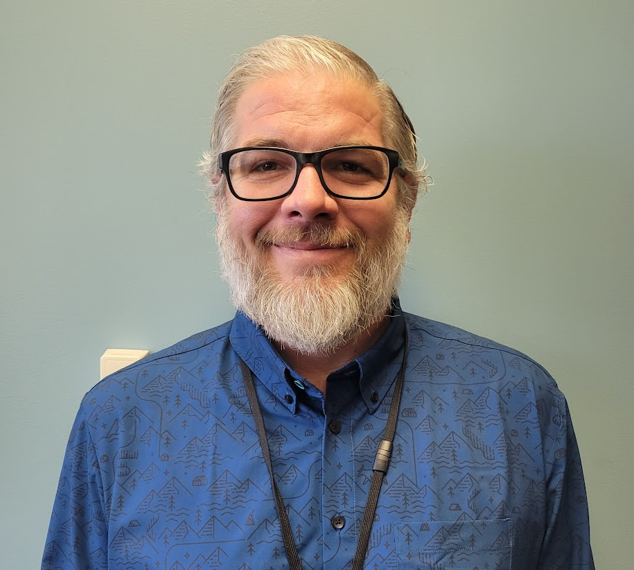 A man with a beard and glasses.