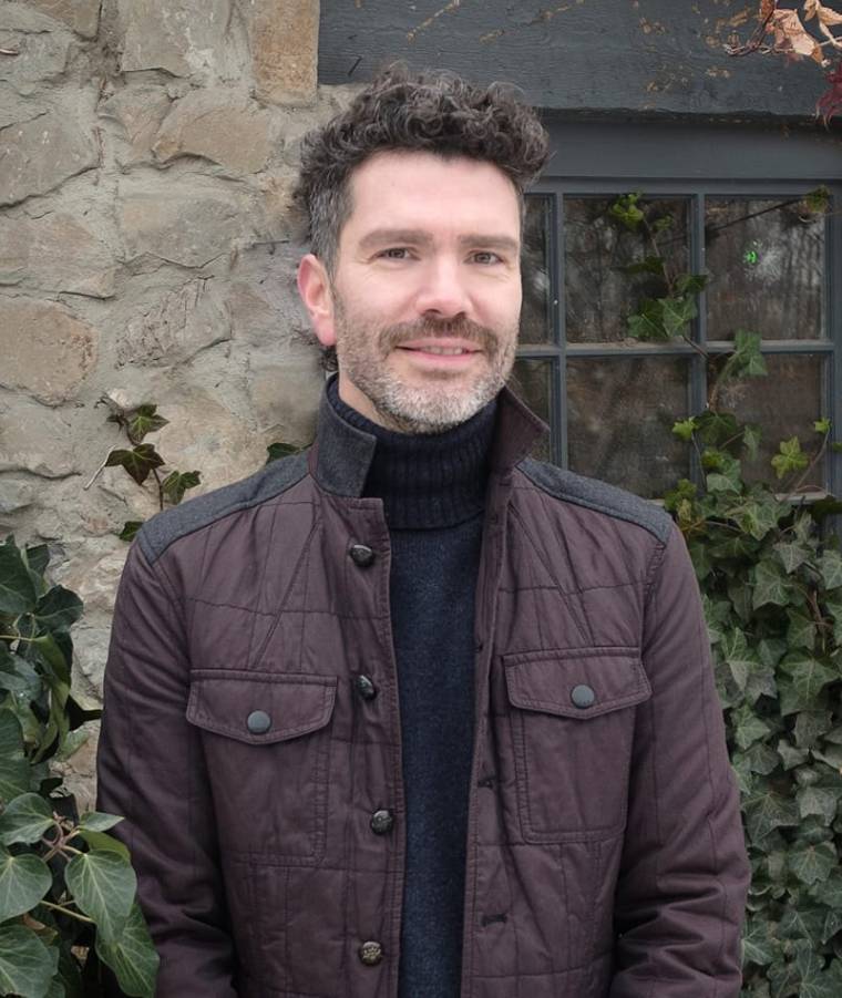 A man wearing a brown jacket.