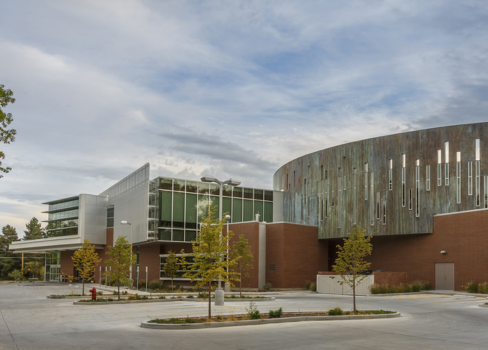 A large building with a parking lot.