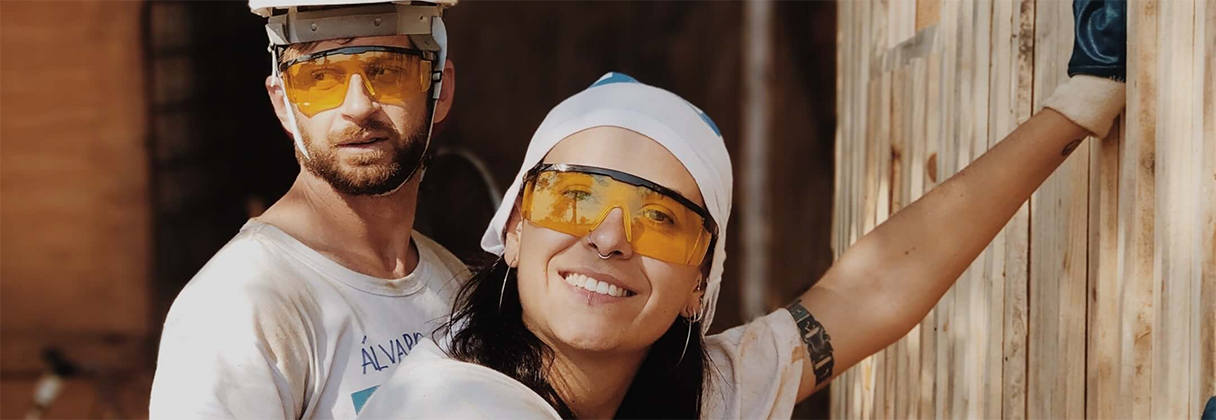 A man and woman wearing hard hats.