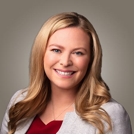 A woman with long hair smiling.