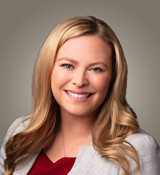 A woman with long hair smiling.