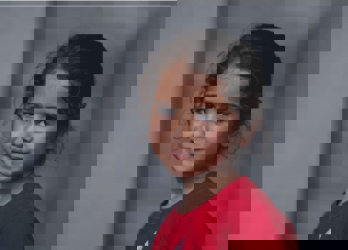 A young girl smiling.