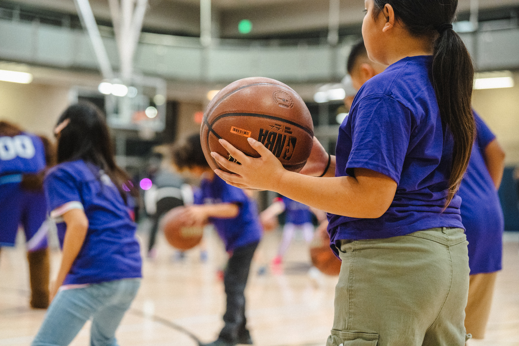 A girl holding a basketball.