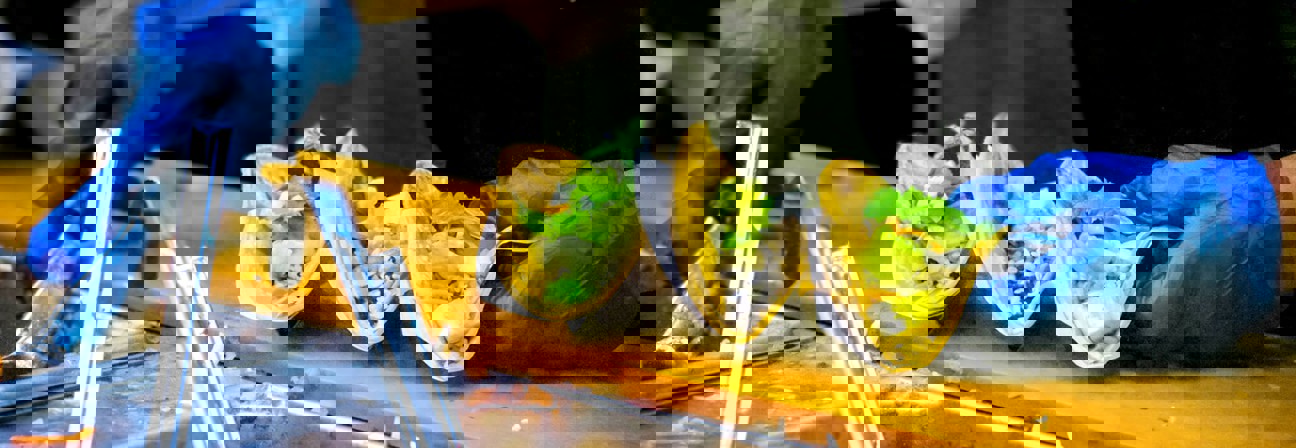 A person holding a tray of food.