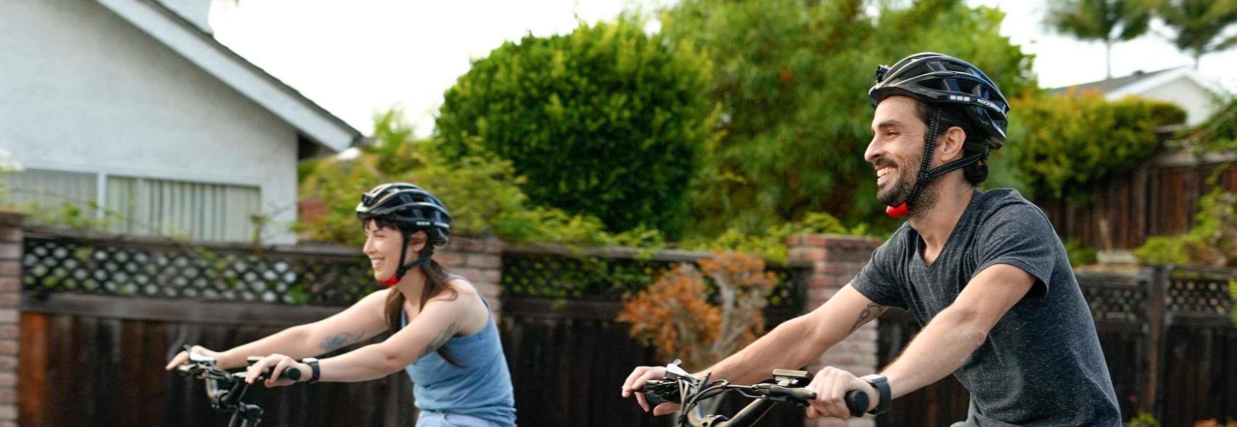 A man and a woman riding bikes.