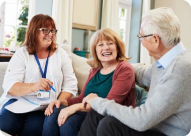 A few people sitting and smiling.