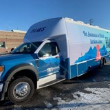 A blue truck parked in a parking lot.