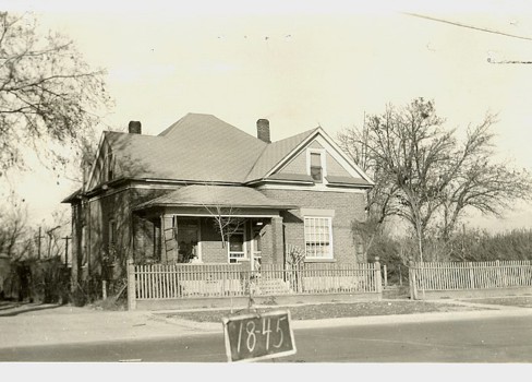 A house with a sign in front of it.