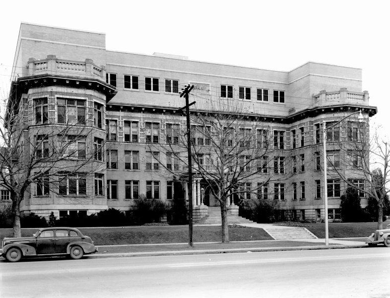A large building with a parking lot.