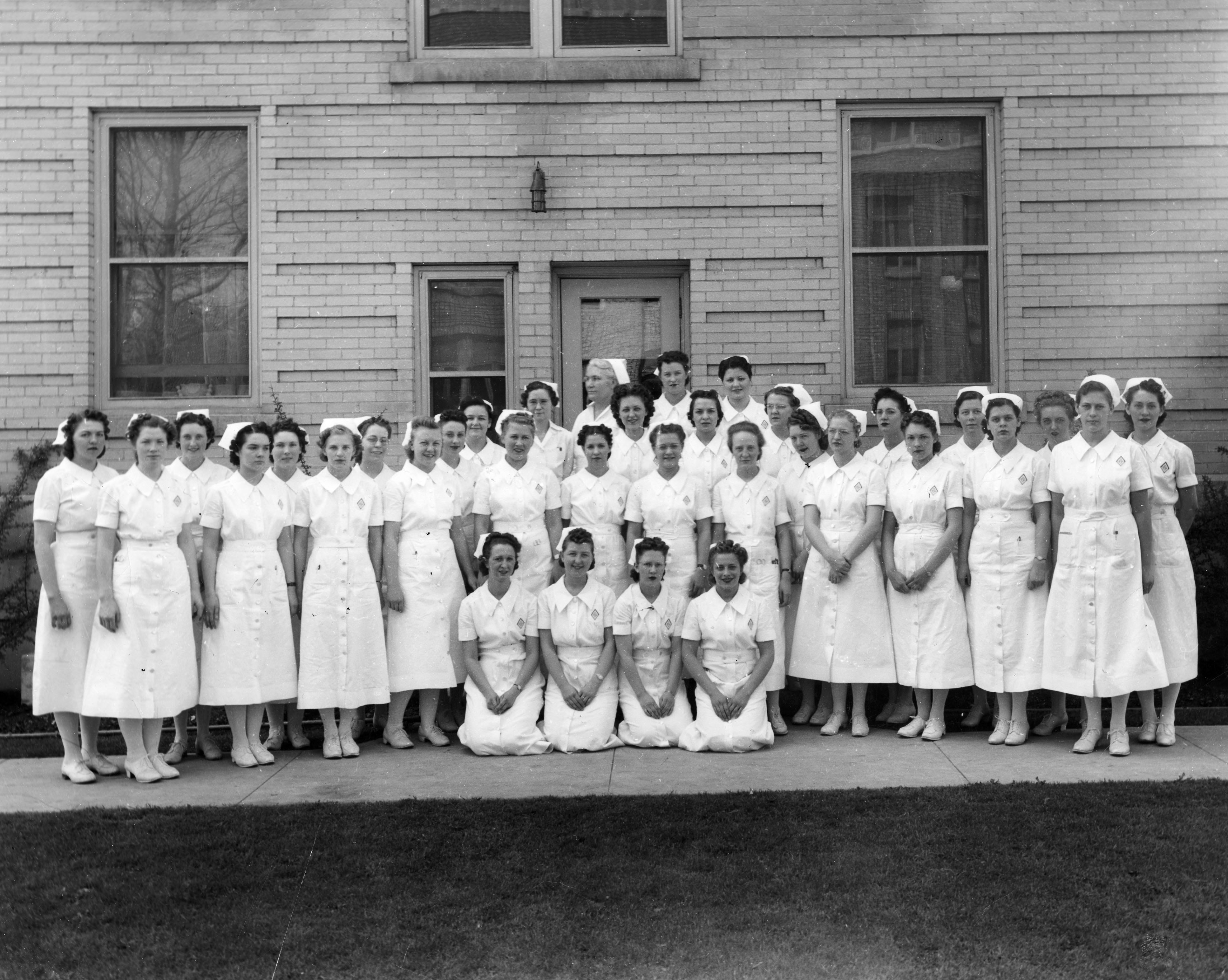 A group of women in white dresses.