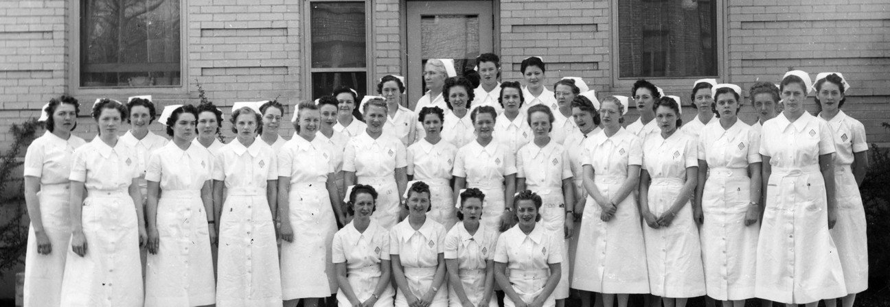 A group of women in white dresses.