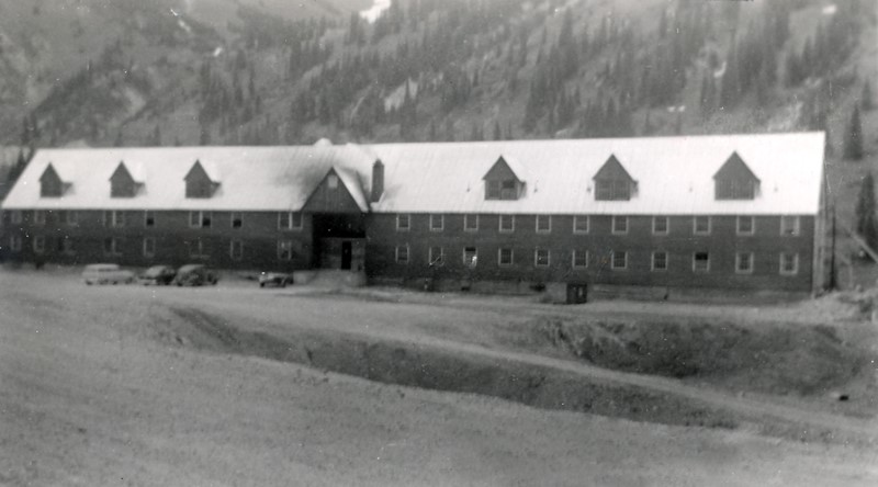 A building with a field in front of it.