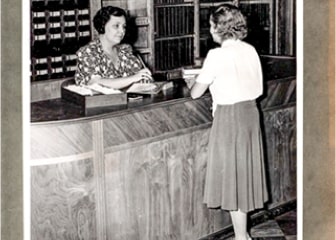 A person standing next to a counter.