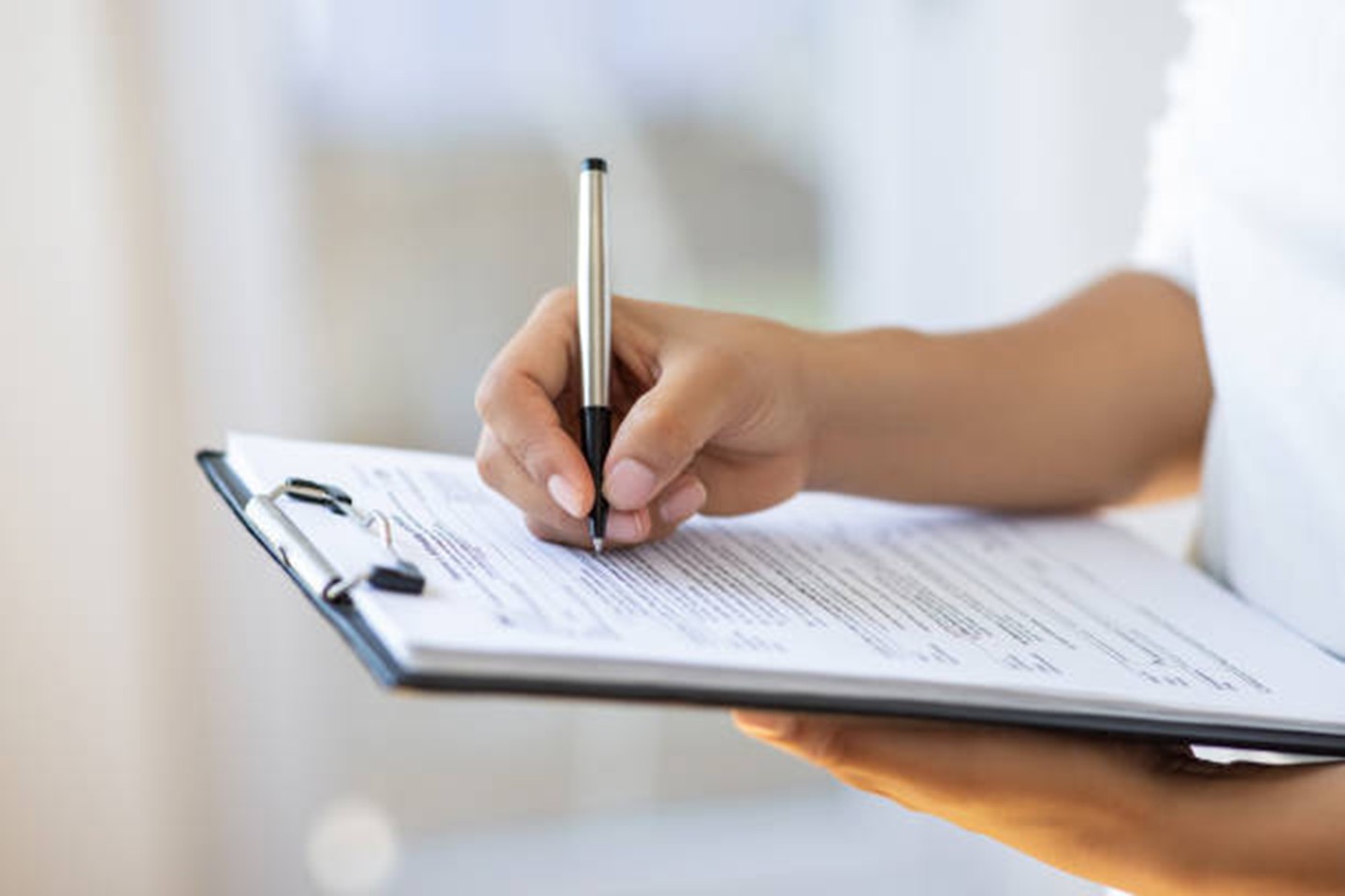 A hand holding a pen.