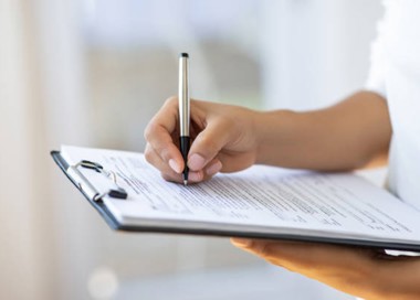 A hand holding a pen.