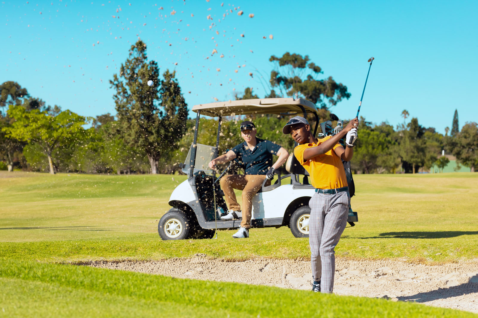 A man and a woman playing golf.