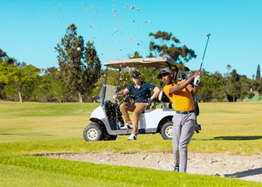 A man and a woman playing golf.