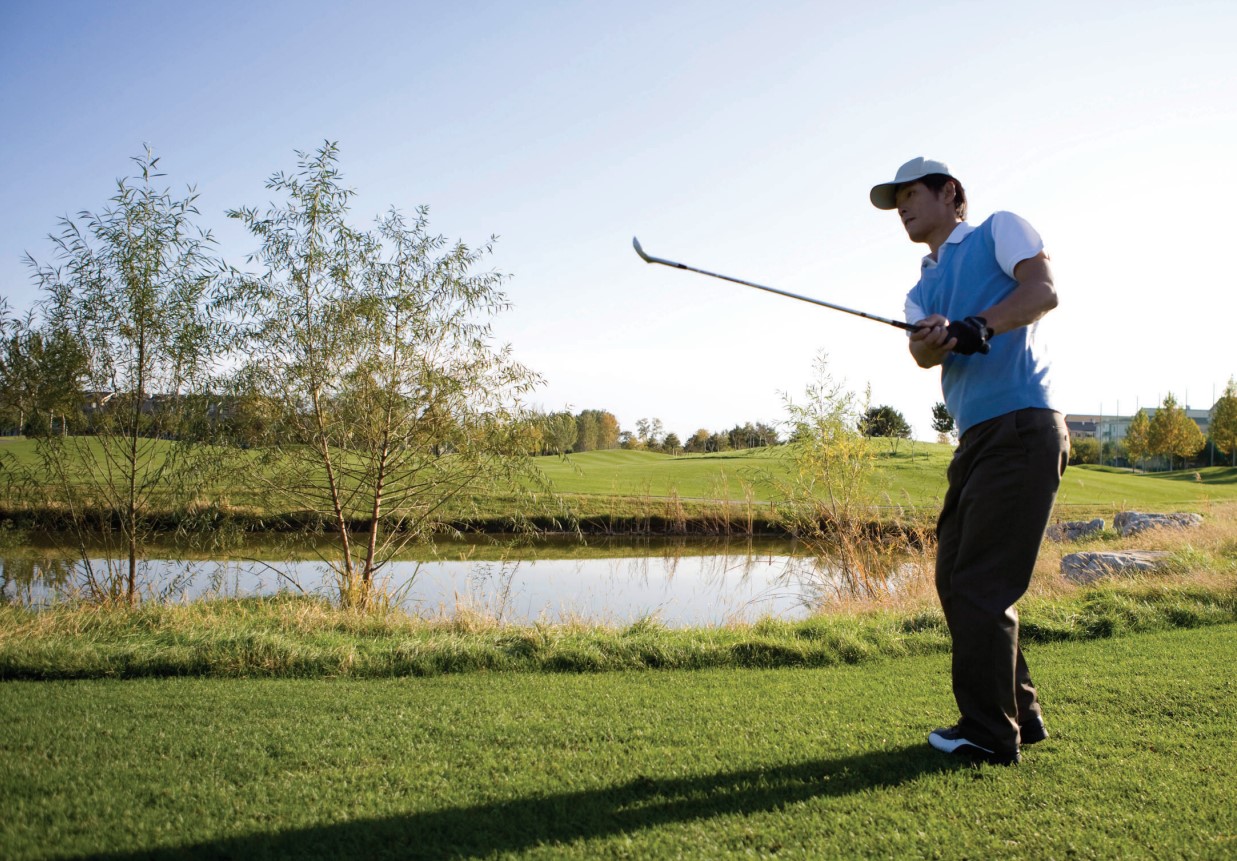 A man swinging a golf club.