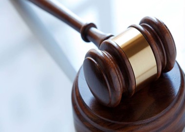 A gavel on a wooden surface.
