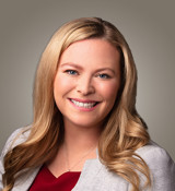 A woman with long hair smiling.