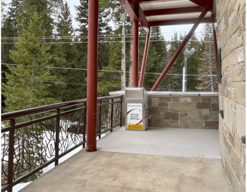 A metal gate with a box on it.