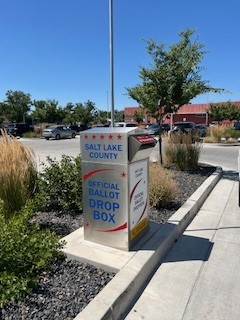A row of mailboxes on a sidewalk.