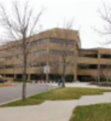 A building with trees in front.