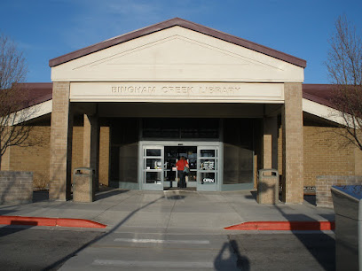 A building with a person standing in the doorway.