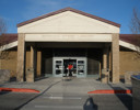 A building with a person standing in the doorway.