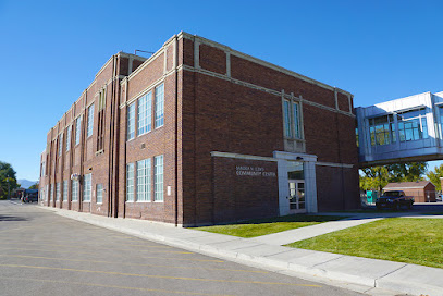 A brick building with a parking lot.