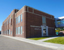 A brick building with a parking lot.