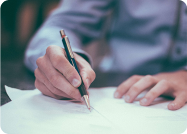 A person writing on a piece of paper.