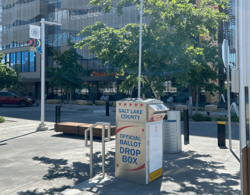 A row of mailboxes on the sidewalk.