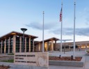 A building with a flag pole and a sign in front of it.