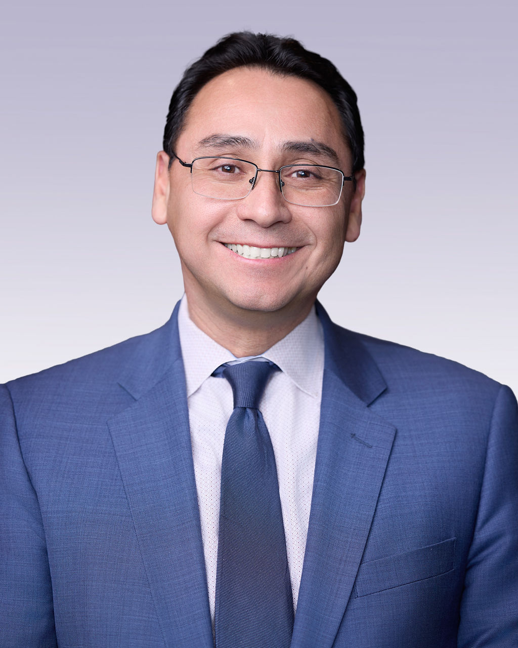 Ross I. Romero wearing a blue suit and tie.