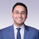 Ross I. Romero wearing a blue suit and tie.