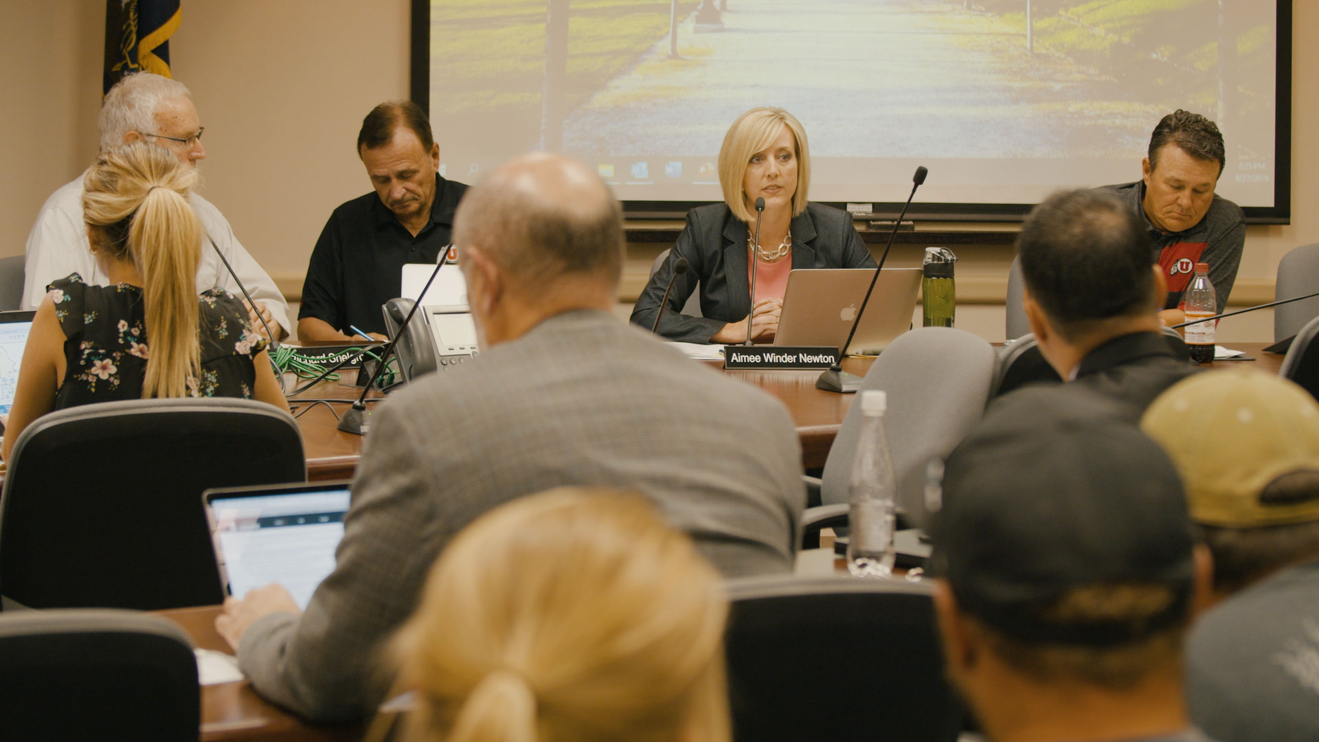 Aimee Winder Newton et al. sitting in a room.