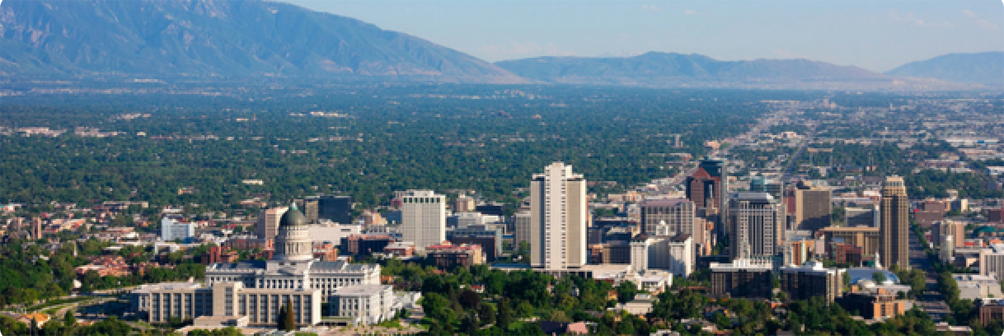 A city with mountains in the background.