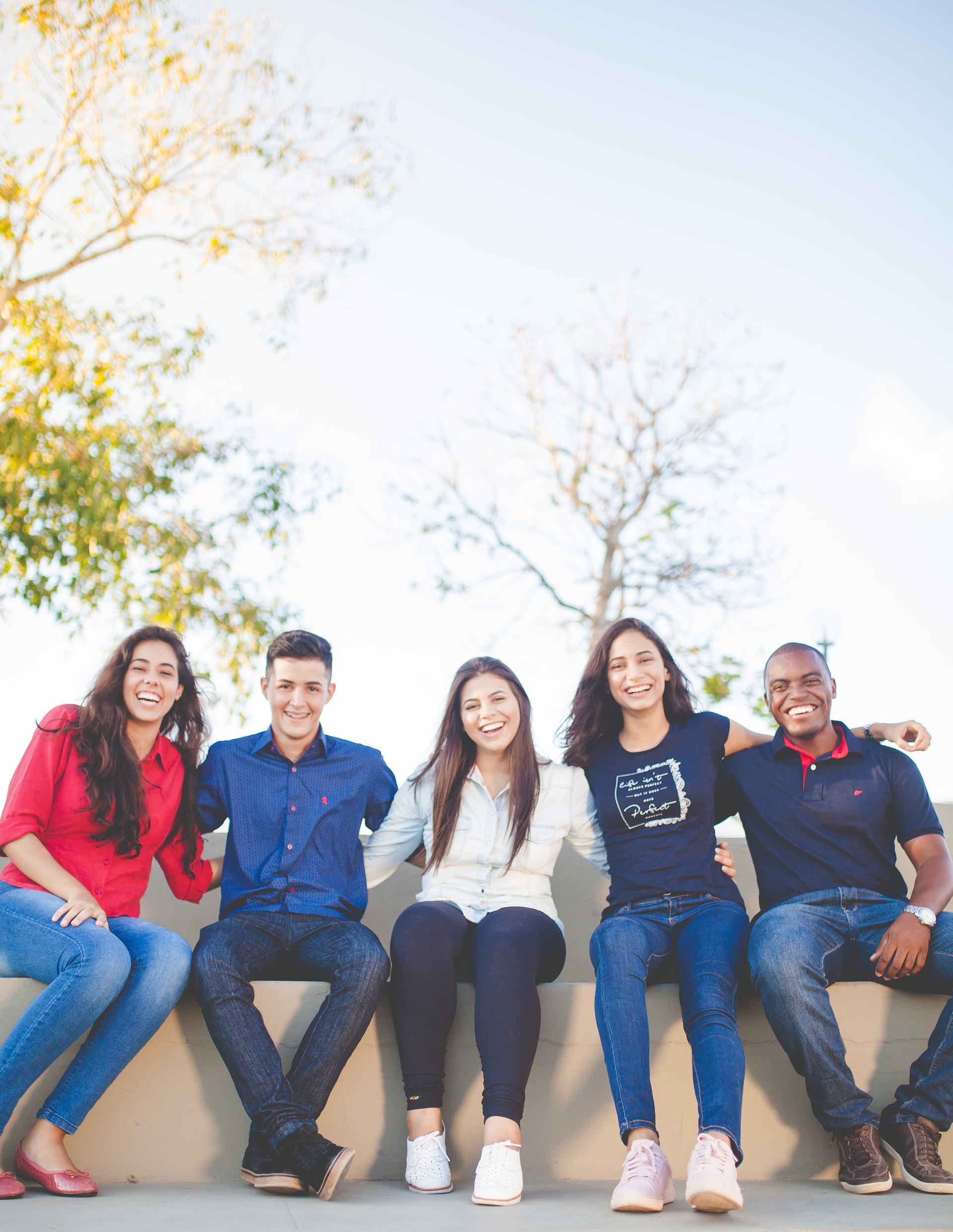 A group of people sitting together smiling.