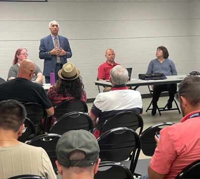 A man speaking to a group of people.