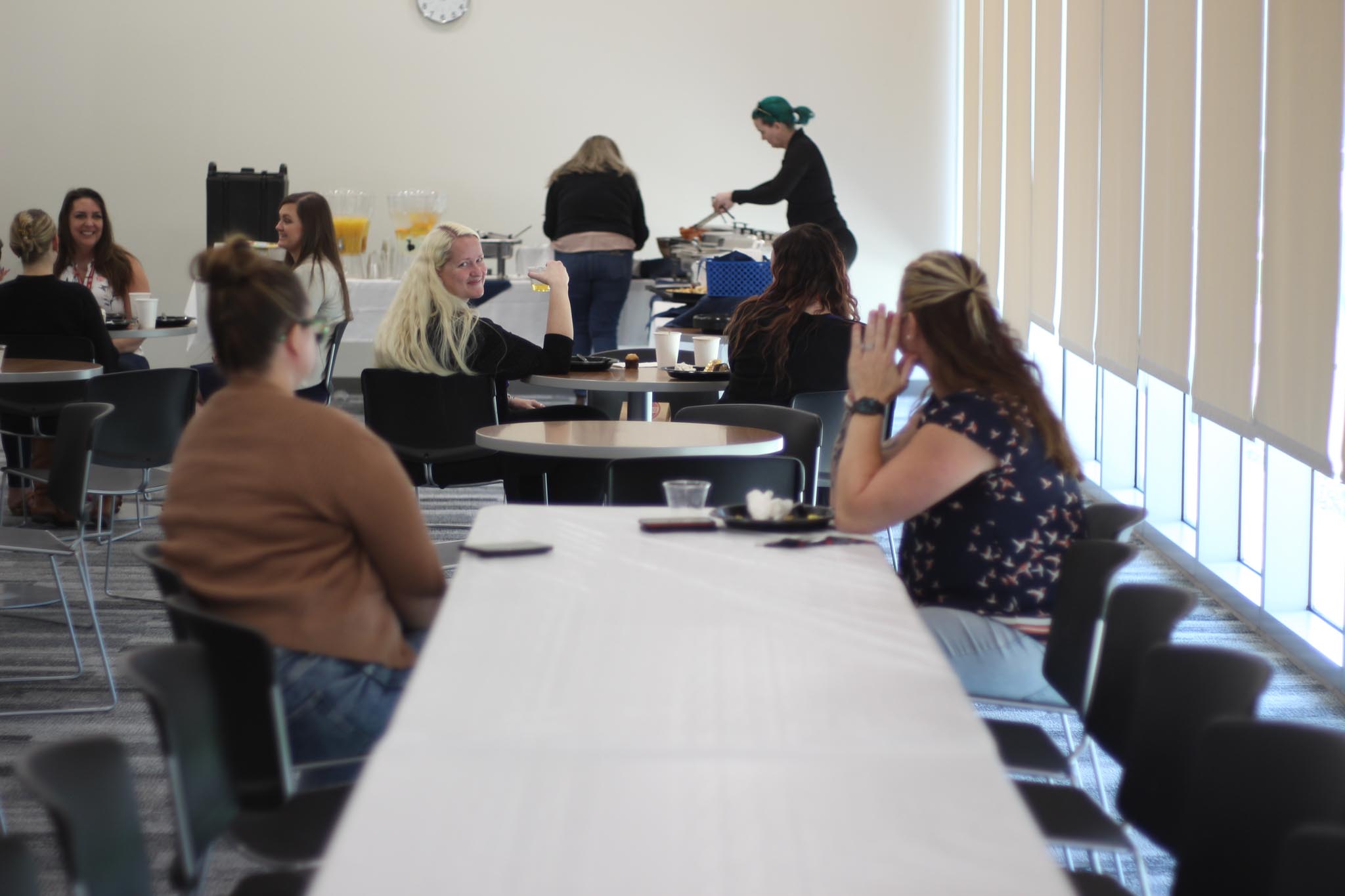 A group of people sitting at tables.