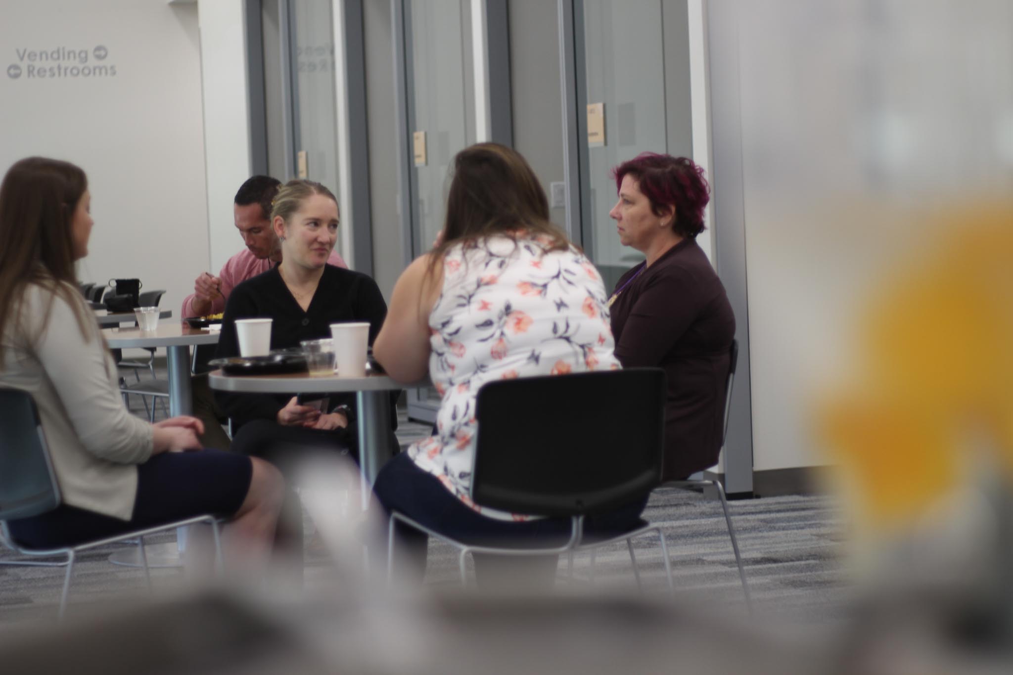A group of people sitting around a table.