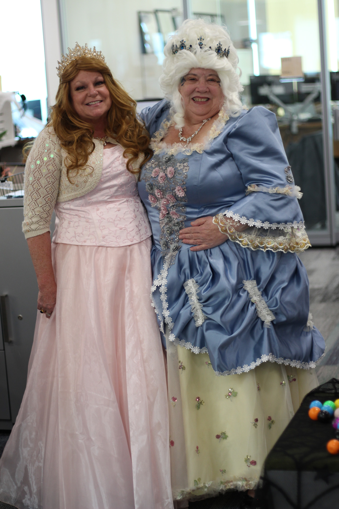 A person in a garment next to a person in a dress.
