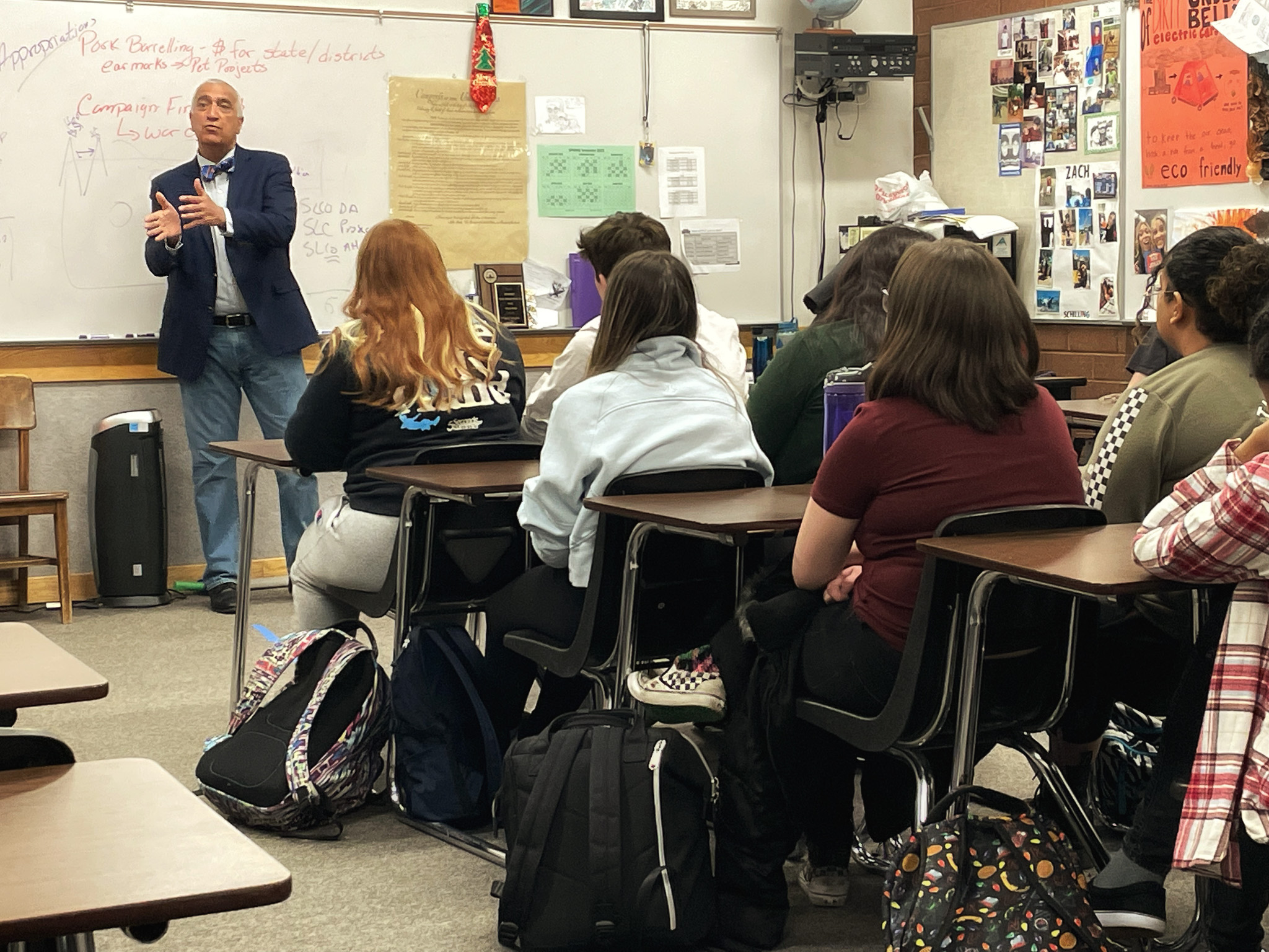 A person standing in front of a classroom of students.