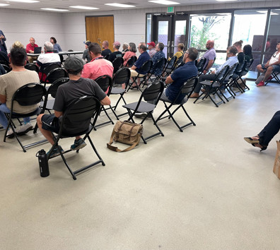A group of people sitting in chairs.