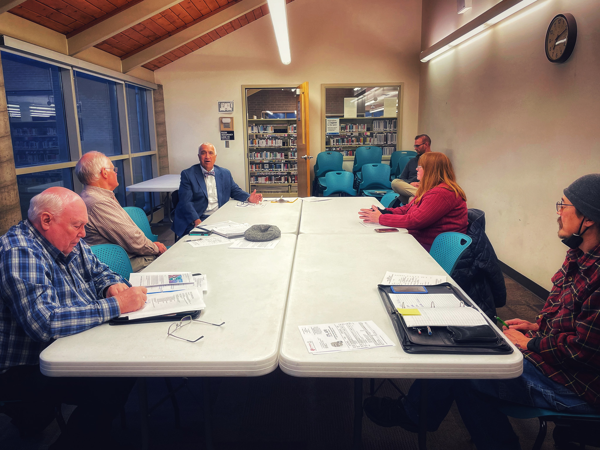 A group of people sitting around a table.