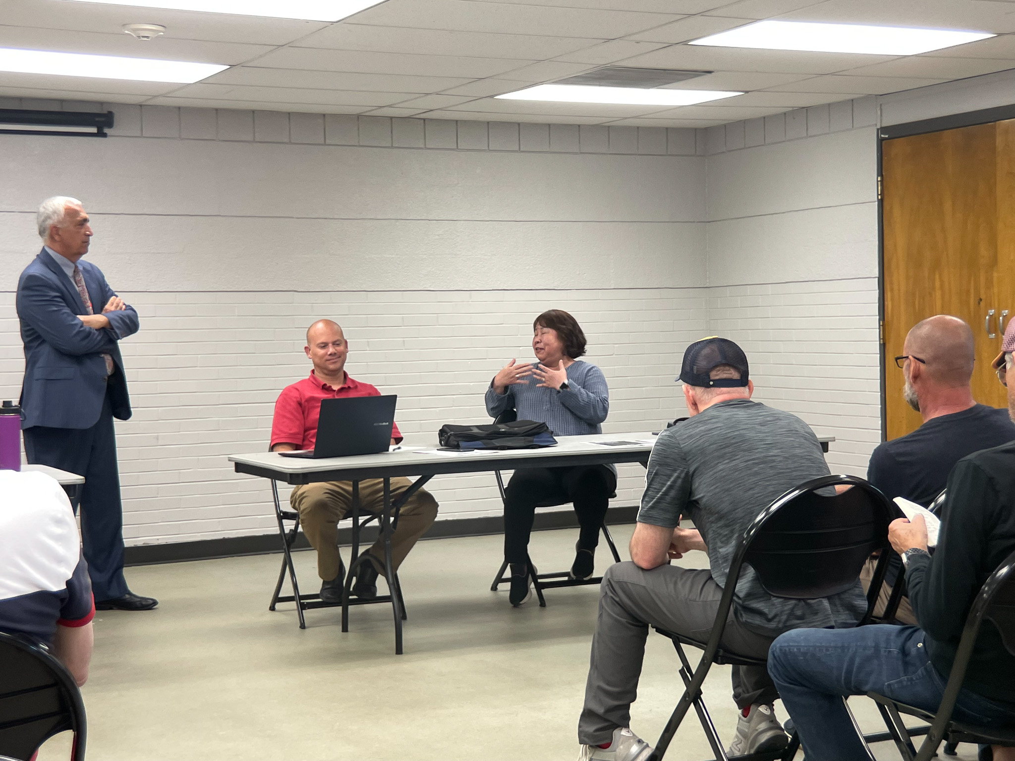A group of people sitting around a table.